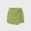 Luxury kiwi green bikini skirt featuring a signature gold ring detail and softly gathered front in vibrant green.
