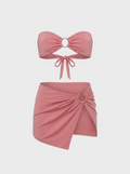 Model wearing the luxury pink bikini skirt in Rosé—a versatile resort wear piece with a sculpting fit and gold ring hardware